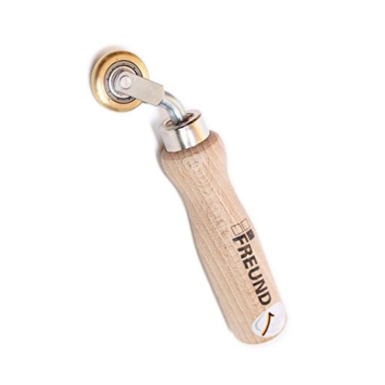 Freund Brass Pressure Roller with narrow convex brass wheel, solid mounting bracket, and ergonomic wooden handle